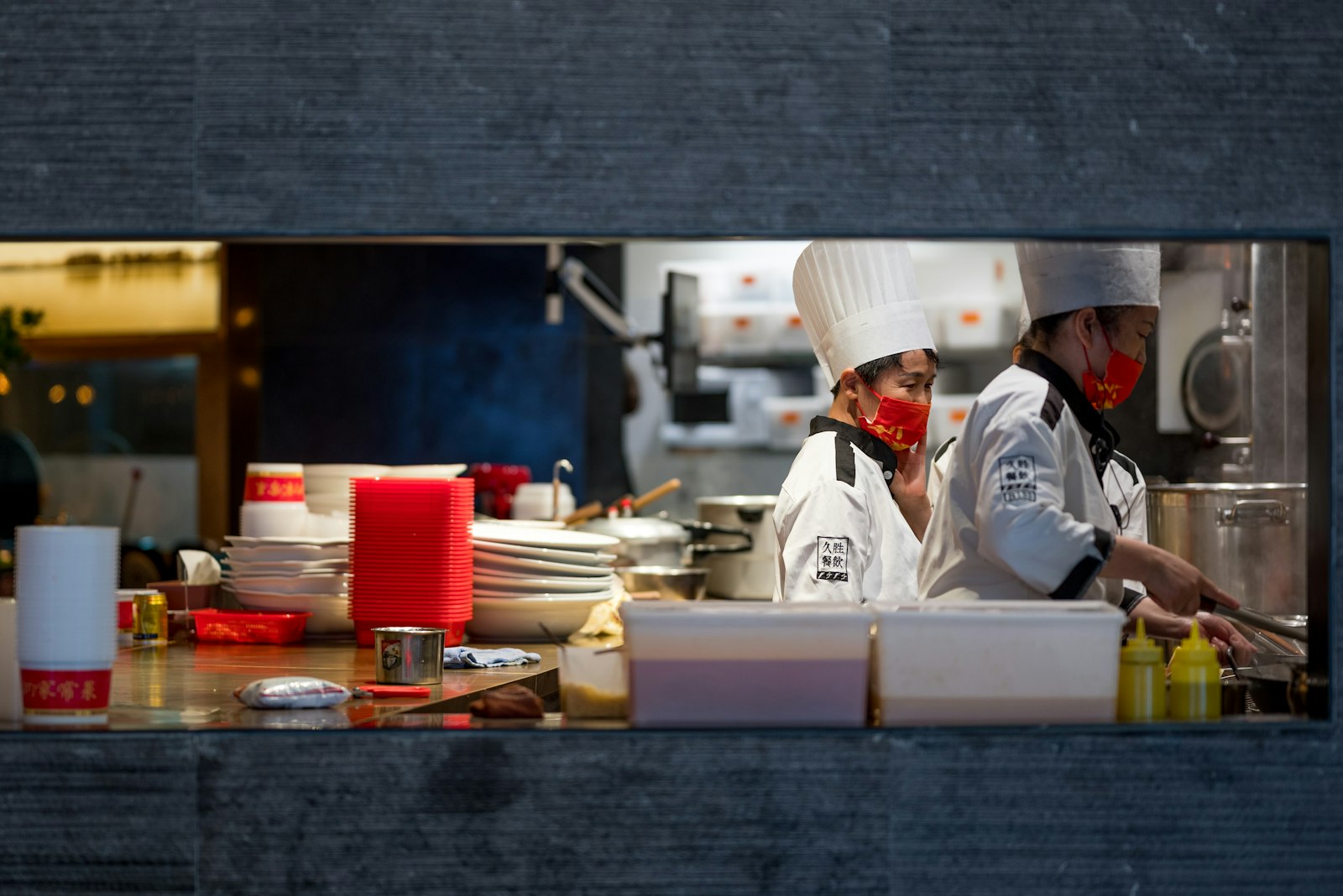 Two chefs standing together in a restaurant kitchen, the team behind every shift